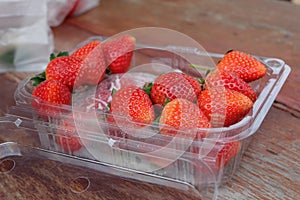 A plastic box of Strawberries