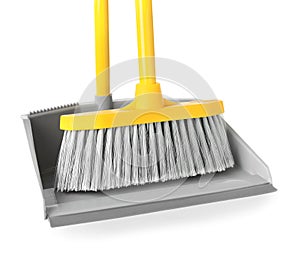 Plastic broom and dustpan on white background