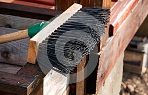 Plastic broom with wooden handle close up shot