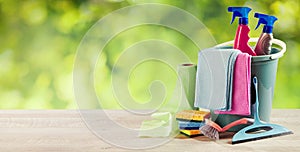 Plastic bucket with cleaning supplies outdoors