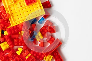 Plastic building blocks on white background. Top view. Copy space.