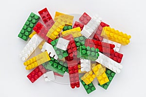 Plastic building toy blocks on white background. Pile of colorful childrens building bricks on white background