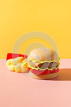 Plastic burger with on yellow