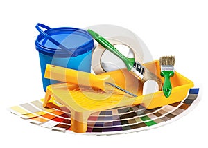 Plastic can with paint, roller, brushes isolated on white
