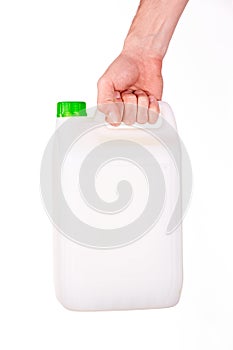 Plastic canister in hand on white background