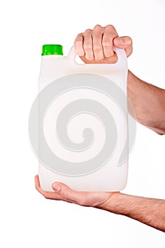 Plastic canister in hand on white background