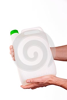 Plastic canister in hand on white background