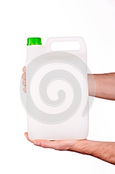 Plastic canister in hand on white background