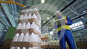 Plastic canisters are being packed under control of a male technician