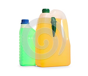Plastic canisters with different liquids for car on white
