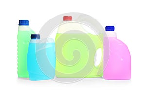 Plastic canisters with different liquids for car on white