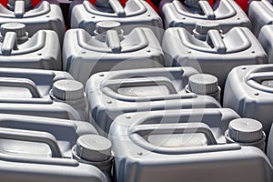 Plastic canisters of grey color in the warehouse