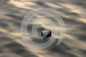 Plastic cans garbage floating on the sewage water