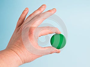 Plastic cap from a disposable plastic bottle in a woman& x27;s hand. Concept of earth day, zero waste and plastic