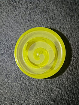 Plastic cap yellow from a PET bottle, with a winning competition code E2DKKR