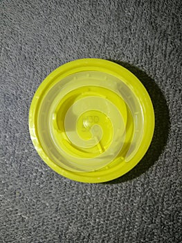 Plastic cap yellow from a PET bottle, with a winning competition code H3D5XC