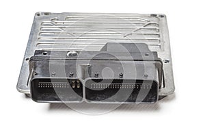 Plastic car engine control unit with metal elements on a white  background is the connecting center of various subsystems