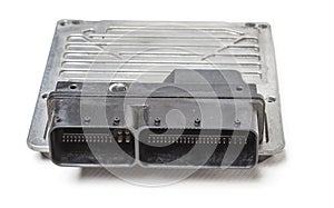 Plastic car engine control unit with metal elements on a white  background is the connecting center of various subsystems photo
