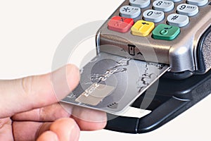 Plastic card in hand, credit card payment through the terminal, Purchase and sale of goods and services, selective focus