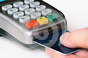 Plastic card in hand, credit card payment through the terminal, Purchase and sale of goods and services, selective focus