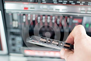 Plastic cassette audio tape in a man's hand