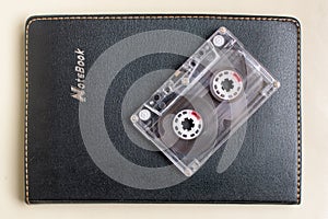 Plastic cassette on a black notebook