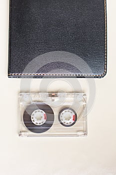 Plastic cassette and black notebook