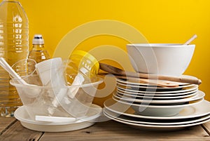 Plastic and Ceramic Stack dishes Recycle Concept Save Planet Yellow Background