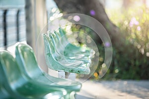 Plastic chairs fixed at bus stop stations with sunlight background