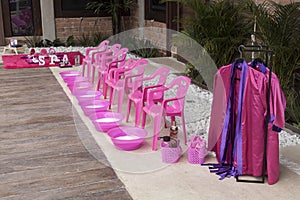 Plastic chairs with punch bowls arranged to do foot treatments for girls; spa theme children`s party