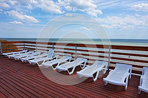 Plastic chaise lounges stand near the pool