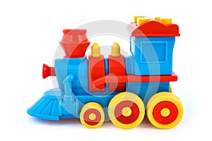 Plastic children`s toy locomotive isolated on white background