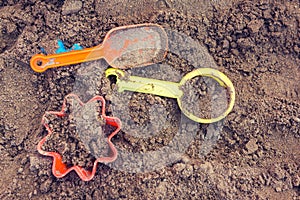 Plastic children toys in sandpit or on a beach