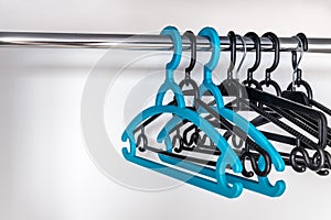 Plastic Clothes Hangers Hanging On A Metal Rod