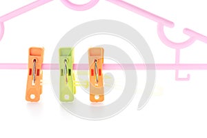 Plastic clothes pegs isolated on white background.