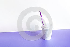 Plastic Coffee glass with a straw on a lilac background. Takeaway,