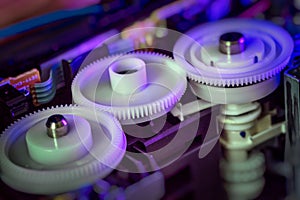 Plastic cogs and gears inside printer.