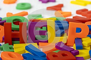 Plastic colored letters spelling word HELP