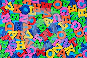 Plastic colorful alphabet letters on a blue