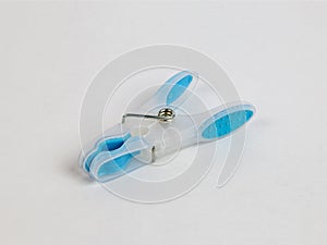 Plastic colorful blue clothes line peg on white background