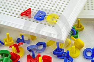 Plastic colorful pins with a white perforation plate