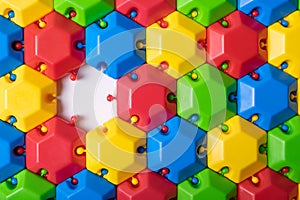 Plastic colorful puzzle constructor with one missing link. Can be used as a colorful abstract background or as an idea of a