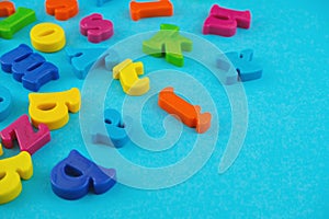 Plastic colourful alphabet letters on the blue background