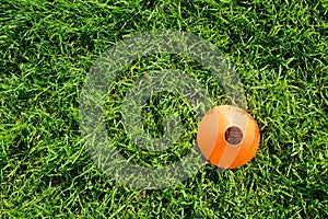A plastic cone marker used in exercise and open air gym training on grass.