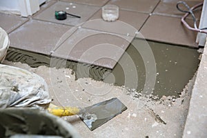 A plastic construction bucket with cement based glue ready to be used for gluing ceramic tiles.