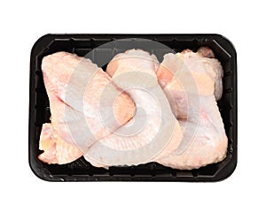 Plastic container with raw chicken wings on white, top view. Fresh meat