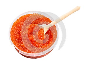 Plastic container with red caviar and big spoon