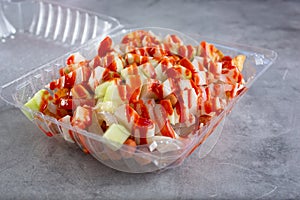 plastic container of tostilocos