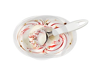 Plastic container with vanilla-strawberry ice cream and nuts