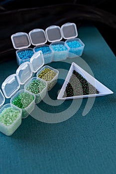 Plastic containers are filled with different colored beads